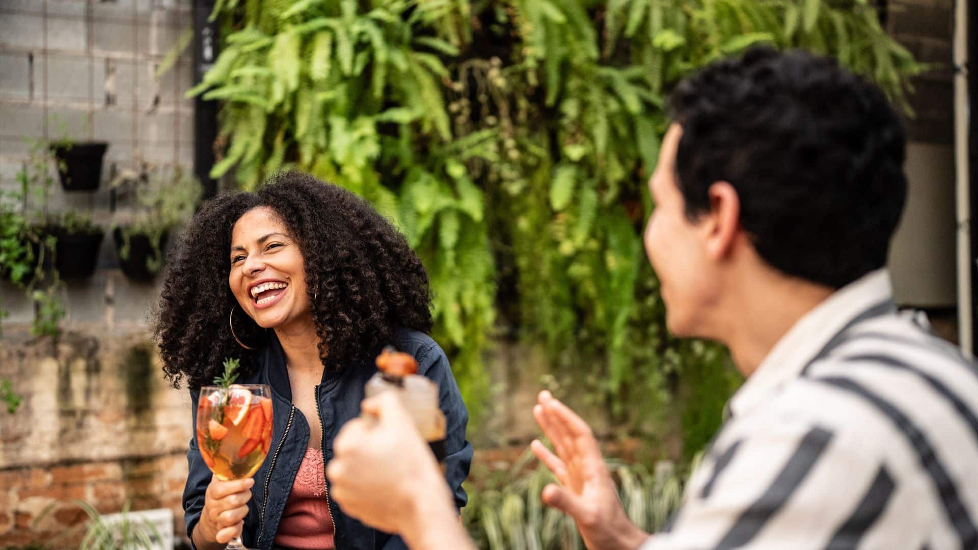 Couple laughing and enjoying a drink